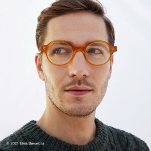 Junger Mann trägt eine orangene Brille von Etnia Barcelona